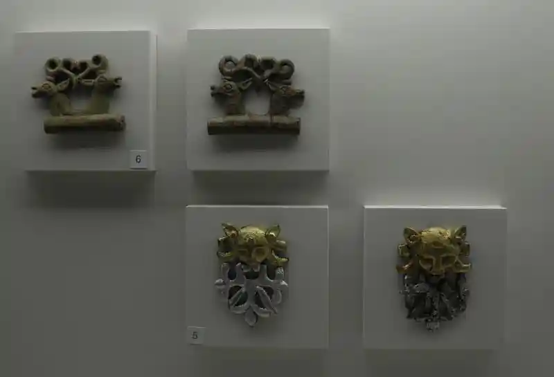 Pendants of cat predator, two elks